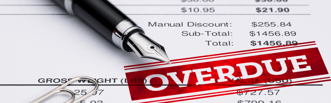 Image of overdue invoice on a desk with pen lying across it